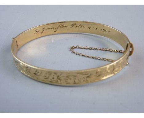 A NINE CARAT ROLLED GOLD HALF BRIGHT CUT BANGLE with presentation inscription 1958, 14.7 grms