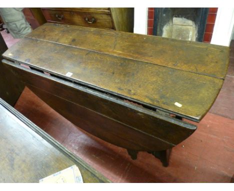 AN ANTIQUE OAK GATE LEG DINING TABLE on bobbin turned and block supports, 75.5 cms high, 124 cms wide, 48 cms deep closed