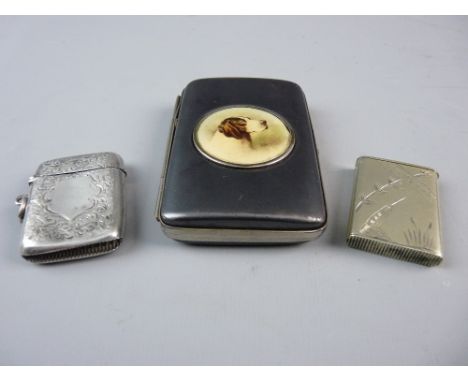 A HALLMARKED SILVER VESTA CASE, Birmingham 1899 with chased decoration and front cartouche, a slim white metal example decora