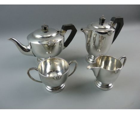 A FOUR PIECE HALLMARKED SILVER TEASET comprising tea and coffee pot with bakelite style handles and finials, cream jug and tw