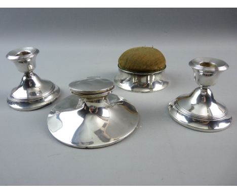 A PAIR OF SILVER SQUAT CANDLESTICKS, a capstan inkwell (no pot) and a lidded pin cushion box in silver holder, all Birmingham