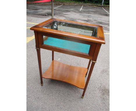 A reproduction glazed top display table with a hinged top and shelf belowLocation: 