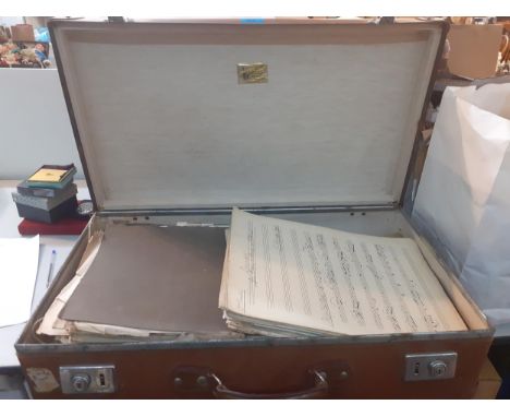 A 1950's globe trotter suitcase with early 20th century sheets of music to include cello, violin, piano and viola sheetsLocat