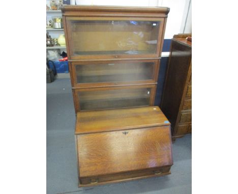 An early 20th century oak Globe Wernicke four-section bookcase, together with a Globe Wernicke bureau 