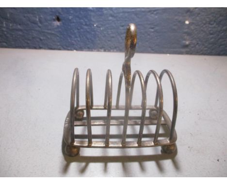 A George V Thomas Bradbury & Sons silver six compartment toast rack with ring handle and ball feet, Sheffield 1928, total wei