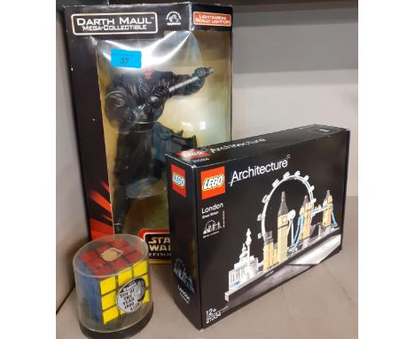 A Star Wars Darth Maul figure with light up lightsabre in original box together with a Rubik's Cube and a Lego Architecture k