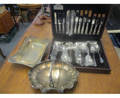 A George Butler of Sheffield stainless steel cutlery set in a wooden effect case, two silver plated handled baskets, and a ph