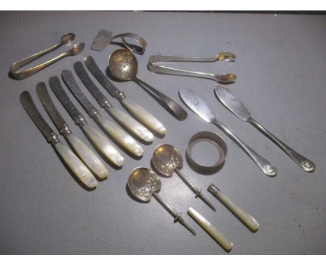 A mixed lot of silver flatware to include six mother of pearl handled fruit knives, sugar tongs, sugar sifter spoon, and othe