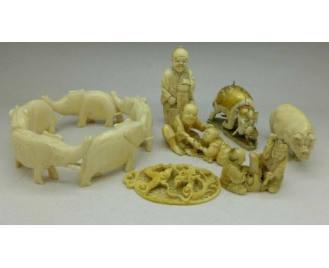 A carved ivory netsuke, a carved ivory dragon pendant, four other carved figures and a carved bangle