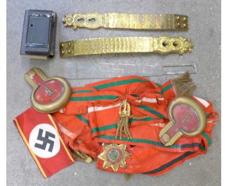 Epaulettes, a sash, a machete blade, a camera and a pair of straps