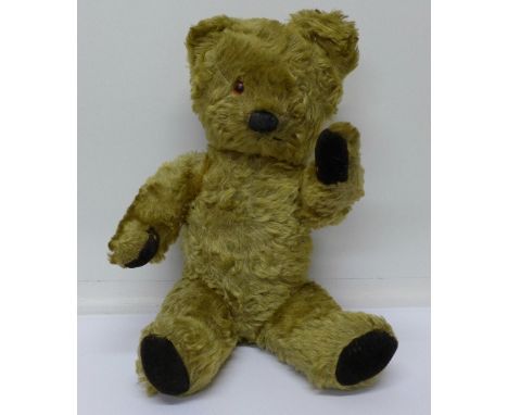A vintage plush jointed Teddy bear