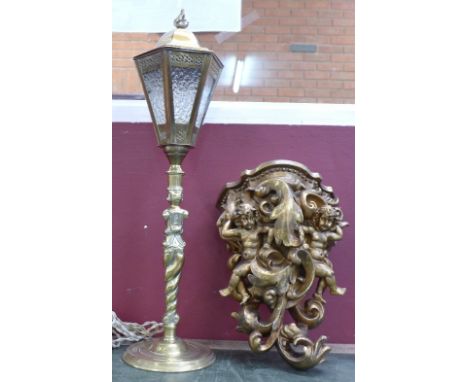 A brass table lamp in the form of a street lamp and a gilt wall bracket