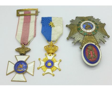 Two continental enamelled cross medals, a large enamelled cross badge and one other badge with damaged enamel