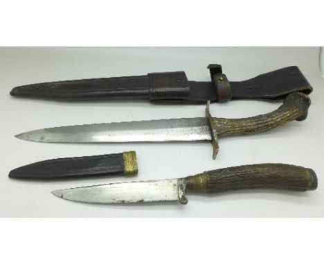 A dagger with horn handle and scabbard, the handle inset with a 1942 German coin and one other dagger with scabbard