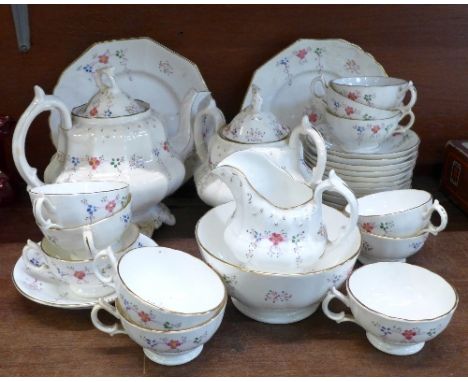 A c.1900 tea service comprising teapot, cream, lidded sugar, a bowl, eleven cups, twelve saucers and two sandwich plates, twe