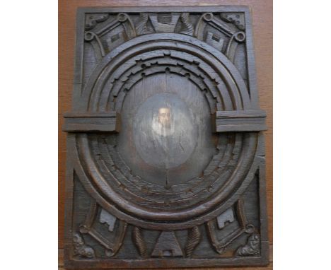 A carved oak 16th or 17th Century panel, with later central portrait, 40cm x 29.5cm