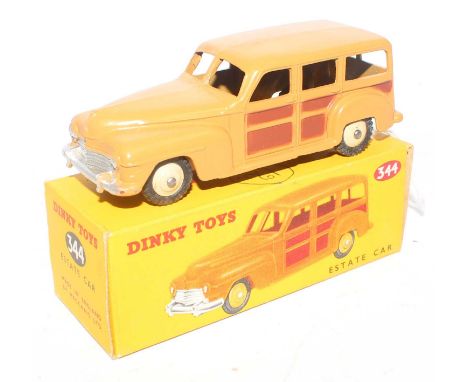 A Dinky Toys No. 344 Estate car comprising of two-tone dark brown and light brown body with dark cream hubs housed in the ori