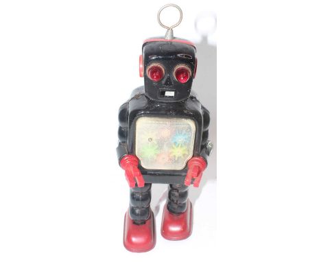 A Yoshiya (KO) of Japan tinplate and clockwork model of a high gear robot, comprising black and red body with single fixed ke