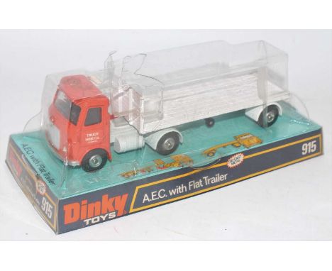 A Dinky Toys No. 915 AEC with flat trailer comprising of orange cab and grey chassis with wide back and truck hire company li