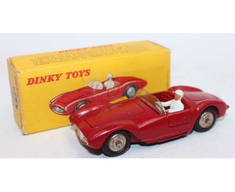 French Dinky Toys No. 22A Maserati Sport 2000 race car in red body with spun hubs and white driver figure, with original wind