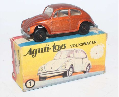 An Aguti Toys of Argentina model No. 1 Volkswagen 1500 saloon finished in metallic orange with black plastic wheels, housed i