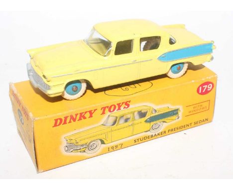 A Dinky Toys No. 179 Studebaker President sedan comprising of yellow and blue body with white tyres and blue hubs housed in t