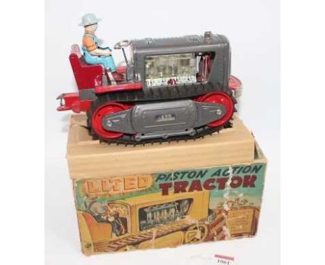 TN Toys of Japan piston action Tractor - tinplate battery operated Tractor is gunmetal grey with red chassis, includes tinpri