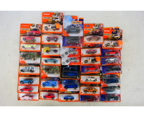 Matchbox - A group of 35 carded and sealed Matchbox diecast vehicles. Lot includes '65 Land Rover Gen II; 2020 Land Rover Def