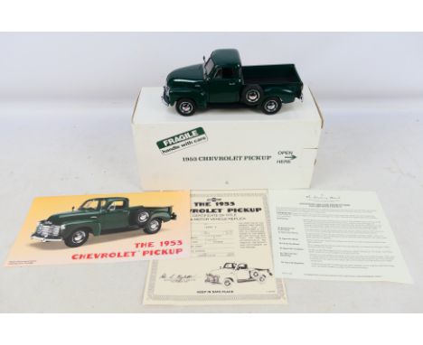 Danbury Mint - A boxed 1/24 scale 1953 Chevrolet Pickup in dark green with certificate of authenticity and other ephemera. It