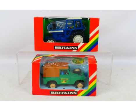 Britains - A pair of diecast vehicles to include #9523 Ford TW20 Tractor and #9571 Farm Land Rover. Items appear to appear to