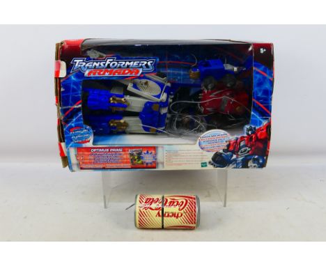 Hasbro - Transformers - A boxed 2003 dated Armada Optimus Prime and an unboxed 1980s Cherry Coke Robot. Optimus Prime is loos