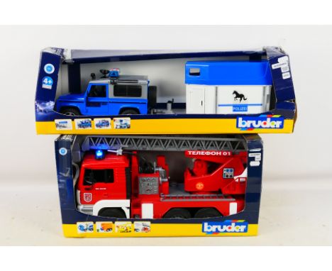 Bruder - Two boxed plastic 1:16 scale emergency vehicles from Bruder. Lot consists of Land Rover Defender police and mounted 