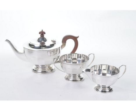 A silver three piece tea service

Of circular form, with a fluted lower body, raised on a circular pedestal foot, the tea pot