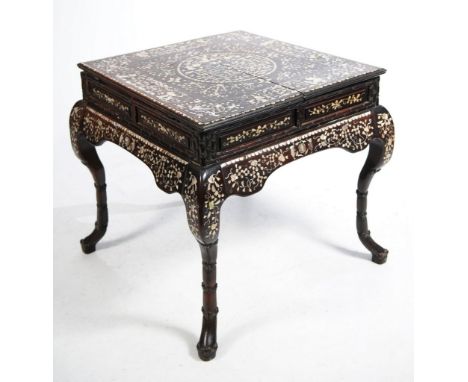 A Chinese inlaid mother of pearl table, late Qing Dynasty (1644-1912)
The square top, raised on four swept supports and termi