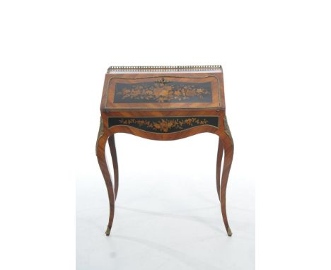 An early 20th Century Louis XV style Kingswood ladies writing desk
The rectangular top with a gilt metal openwork gallery and