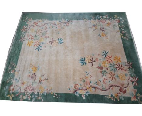 A Chinese green ground carpet 
The rectangular form rug with green border framing a central ivory coloured panel, detailed wi