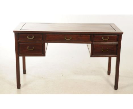 A Chinese Huanghuali  style hardwood writing desk, 20th Century
The single plank top inset within mitred edges with carved li