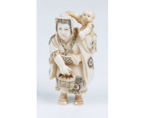 A Japanese ivory netsuke, Meiji/Taisho period 
The well carved and stained figure modelled as a mother and child, her dressed