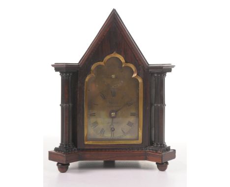 A Victorian rosewood gothic revival mantle clock 
The pointed architectural casing flanked by quatrefoil shaped columns the g