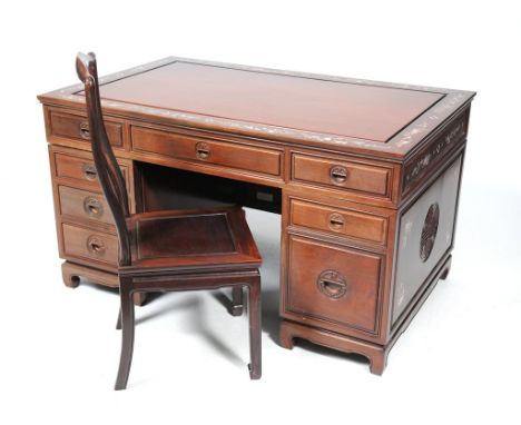 A Chinese Huanghuali style hardwood mother of pearl inlaid writing desk, 20th Century 
The single plank top, set within a wid