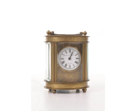 A small oval cased Elliot & Son ladies carriage clock 
The four glass oval form clock raised on four ogee supports and surmou