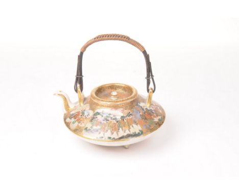 A Japanese satsuma teapot, Meiji Period (1868-1912)
Of compressed globular form, raised on three short swept tripod supports,