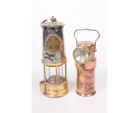 Two miner's lamps, circa 1930 
The first a Ceag Ltd. Barnsley copper and brass example, of cylindrical form, applied with bra