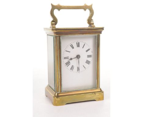 An early 20th Century brass cased carriage clock
The four glass clock with brass corniche case, raised on a canted base, with