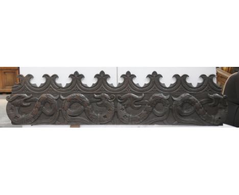 A carved and stained oak panel, probably 19th Century
The rectangular shaped panel, surmounted by a scalloped upper pediment,