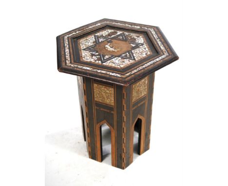 A Moorish hexagonal topped occasional table, early 20th Century 
Raised on a hinged and panelled support base, with cut out a