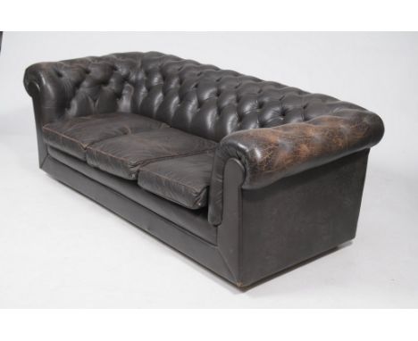 A Mid 20th Century black leather Chesterfield settee
with a button back above three loose cushions , raised on castors 198cms