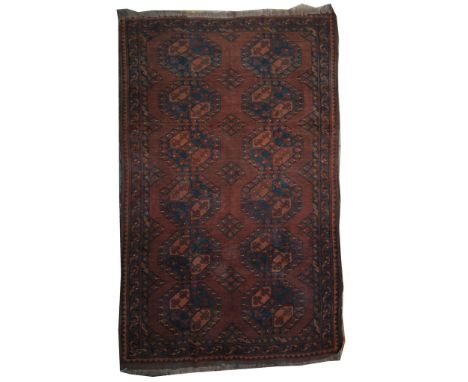 A Persian Azari rug 
The rug of rectangular form with fringed edging, the dark brown umber ground with two central six-medall