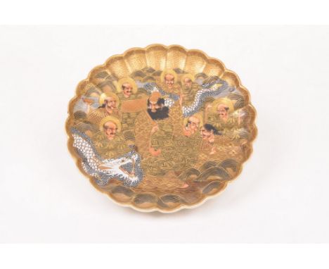 A Japanese satsuma dish, Meiji/Taisho period
Of circular form with lobed rim, the central field with solid gilt and enamel de