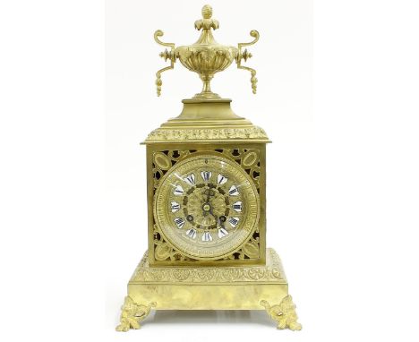 French brass two train ornate mantel clock striking on a bell, the 3.75" gilt pierced foliate dial with Roman cartouche ename